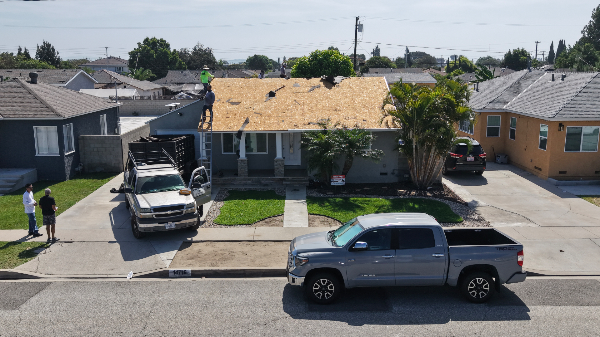 Before: Norwalk home stripped to bare plywood decking during tear-off
