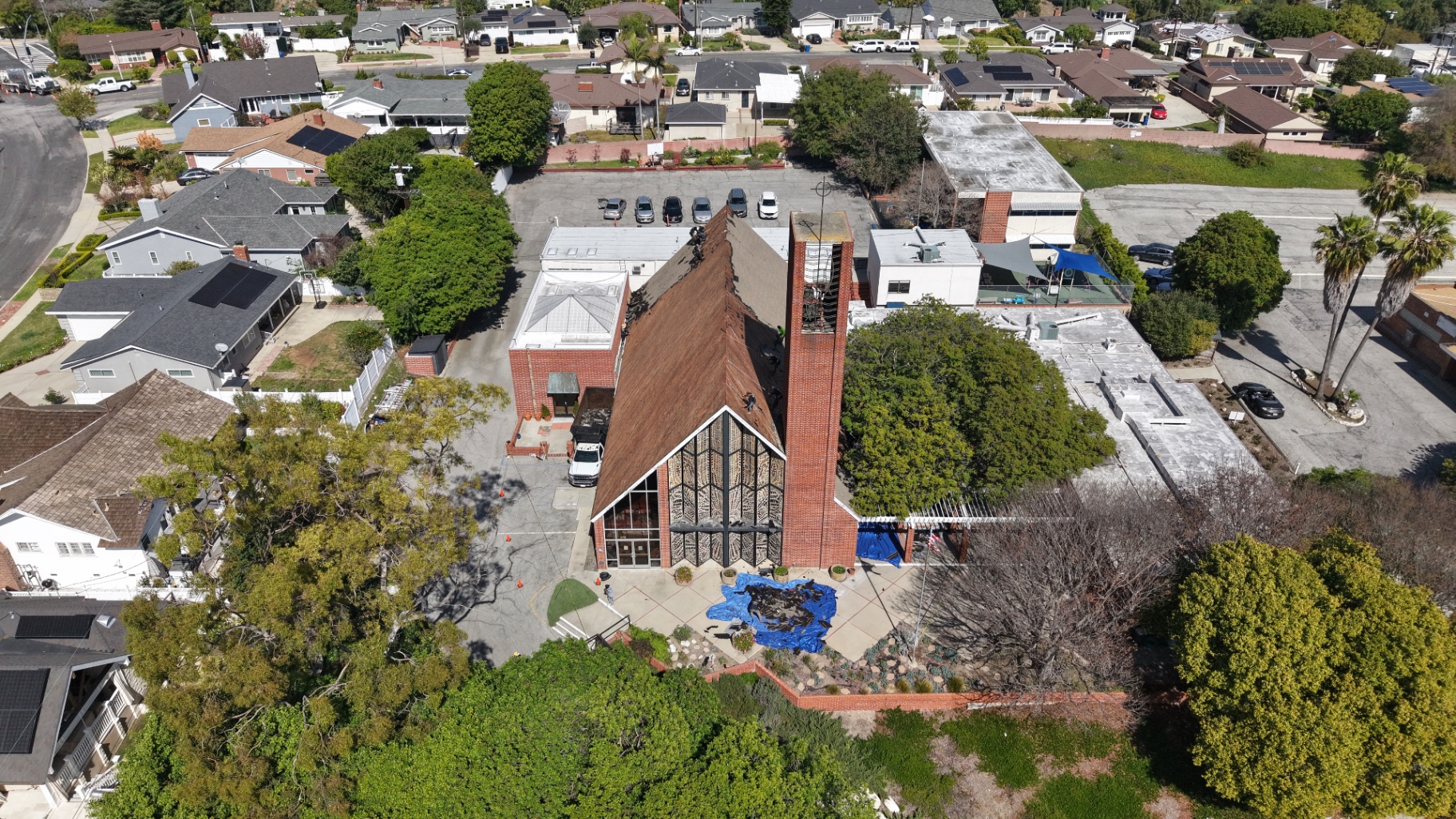 Before: church roof stripped down during tear-off, aerial view