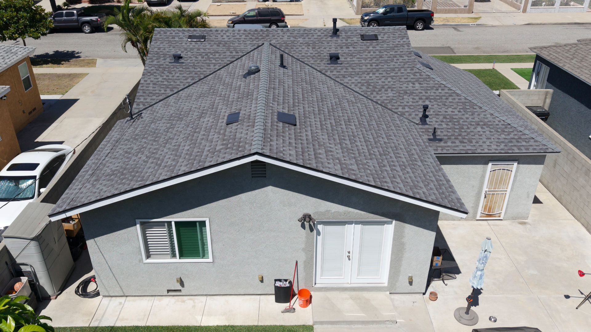 Aerial view of a completed grey shingle re-roof on a residential home